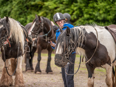 An image of a man thanking the horse for the ride with a big smile on his face.